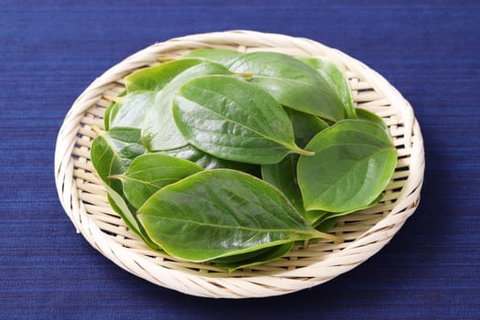 persimmon leaves, herbal medicine in a bamboo basket