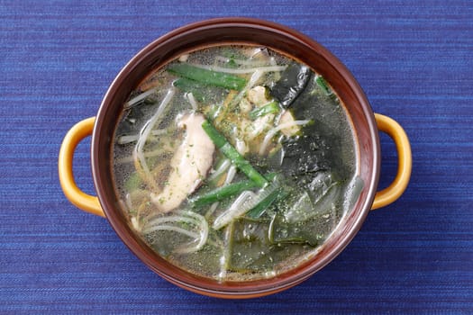 vegetable with pork soup in a dish on table