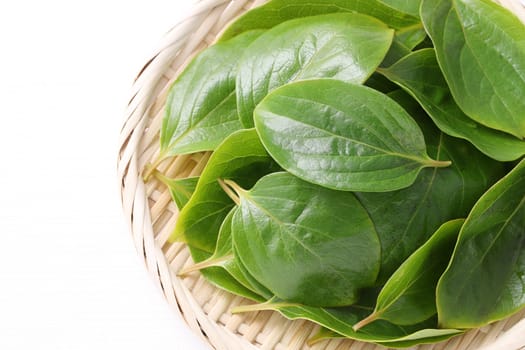 persimmon leaves, herbal medicine in a bamboo basket
