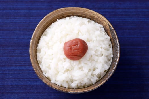 Japanese food, Umeboshi pickled salt plum on white rice in a bowl, top view