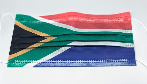 surgical mask with the national flag of South Africa printed. Pandemic covid-19 and preventive measures to counter the spread of the virus
