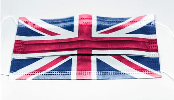 surgical mask with the national flag of England printed. Pandemic covid-19 and preventive measures to counter the spread of the virus