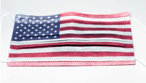surgical mask with the USA national flag printed. Pandemic covid-19 and preventive measures to counter the spread of the virus