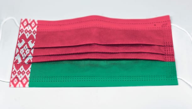 surgical mask with the national flag of Belarus printed. Pandemic covid-19 and preventive measures to counter the spread of the virus
