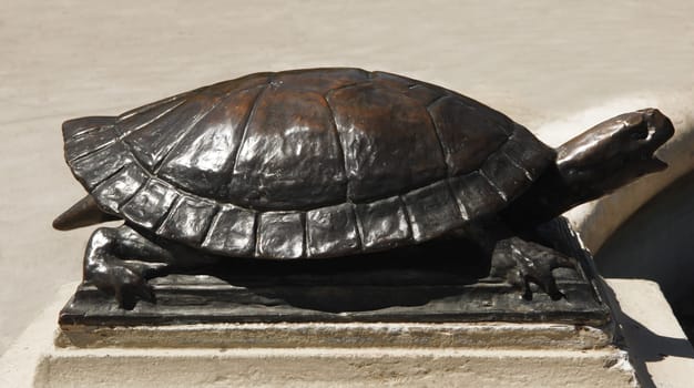 A big bronze turtle on a fountain in a park in Hamilton.