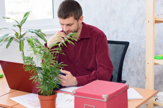 tired office worker does routine work on the desktop