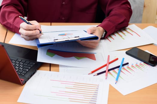 Worker's desktop on statistics with graphs and tables