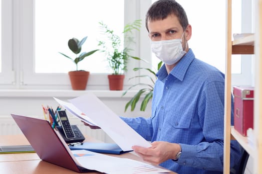 a person in an office in the workplace is studying the data in the documents