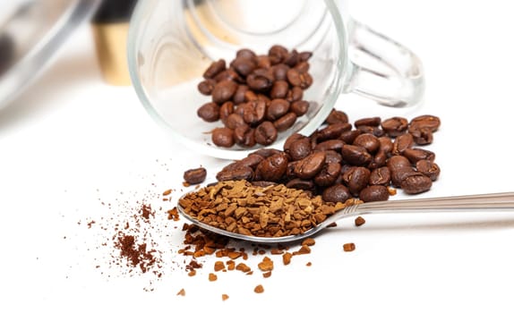 Macro shot of instant granules and beans coffee on a white background.