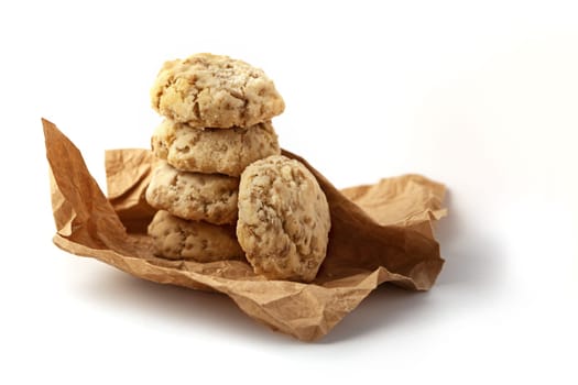 Shortbread with nuts and seeds in craft paper. Isolated on a white background close up