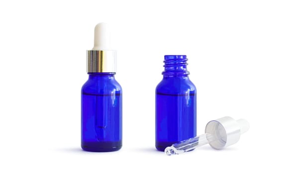 Medicine drops in bottles with a dispenser. Open and closed medicine bottles. Blue containers isolated on white background. With clipping path