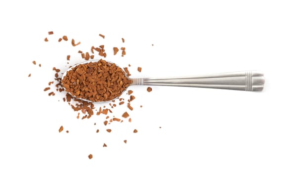 Spoon with instant coffee granules on a white background, top view