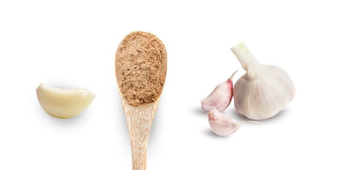 Garlic clove, dry spices in wooden spoon, a whole head of garlic. Isolated on white background