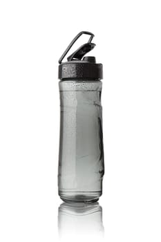 Sports bottle is covered with droplets. Isolated on white background.