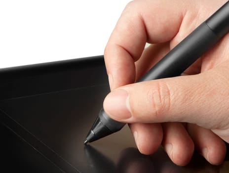 Hand is drawing on a digital graphic tablet with pen