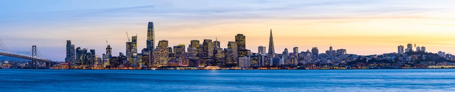 Panoramic cityscape of San Francisco skylines skyscrapers building with Bay Bridge at dusk in North California USA West Coast, San Francisco United States Landmark Travel Destination tourism concept.