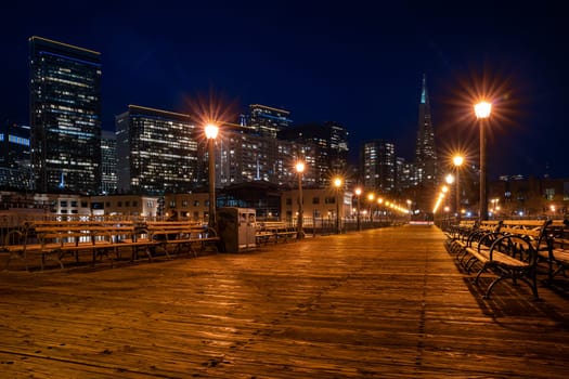 San Francisco downtown cityscape skylines ans skyscrapers building from pier at night in California, USA. San Francisco United States Landmark Travel Destination cityscape urban and tourism concept.