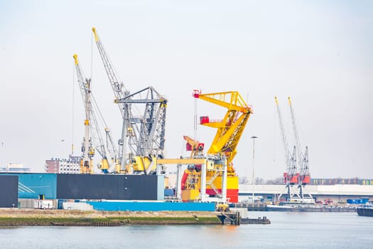 Big Cargo Containers Boat with Goods cargo Stack at the Pier docks port waiting for international sea freight transportation in Rotterdam Port of Netherlands