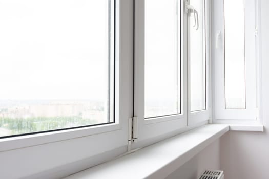 Plastic window sill on a balcony glazed with plastic windows