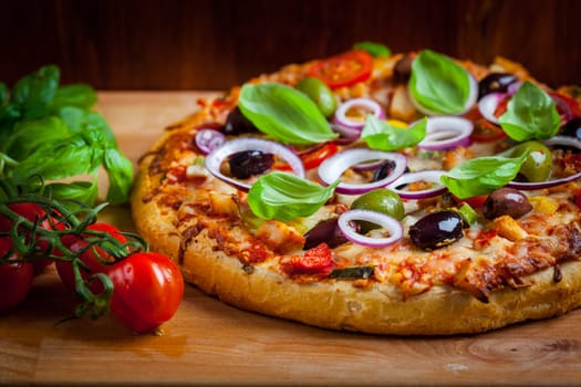 Italian cheese pizza with black olives, onions and basil