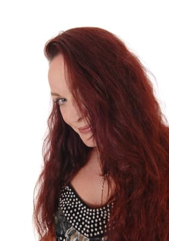 A close up image of the face of a pretty woman looking into the camera.with her blue eyes and long red hair.