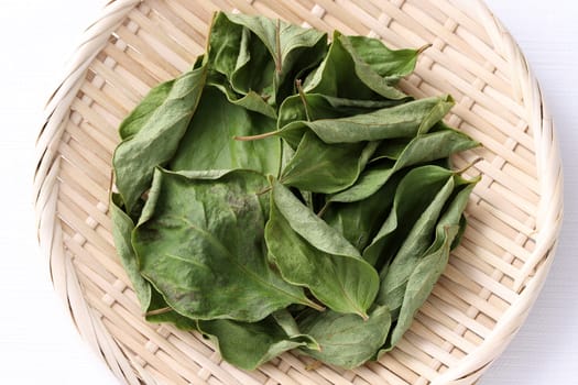 dried persimmon leaves, herbal medicine in a bamboo basket