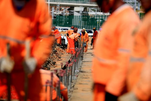 salvador, bahia / brazil - january 12, 2017: Workers are seen working on road construction on Avenida Antonio Carlos Magalhaes in the city of Salvador