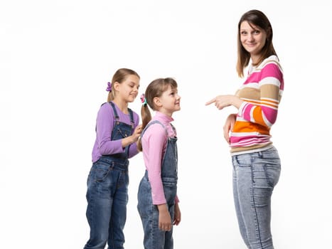 The girl begs the toy from her mother, mother wearily points a finger at the child