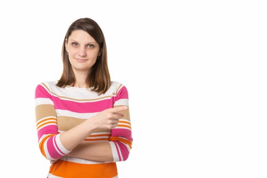 Portrait of a beautiful girl of thirty years of European appearance on a white background, the girl points a finger to an empty place