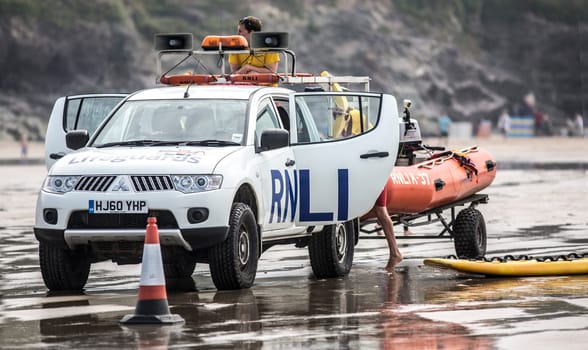 POLZEATH, CORNWALL- UK - JULY 26 : RNLI Lifeguards on duty at Poleath Beach in Cornwall on July 26, 2014.