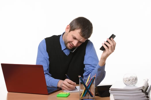 office worker records information received in a telephone conversation