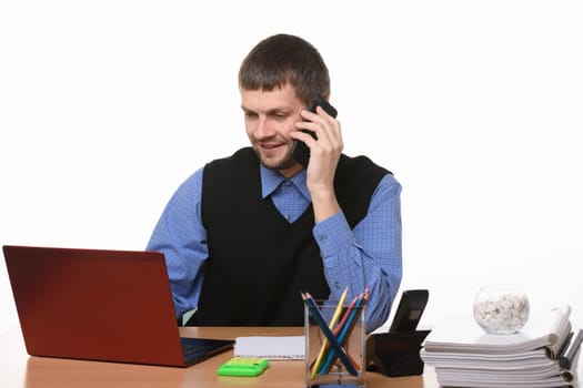 Office worker talks on the phone with customers
