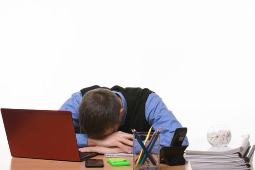 sleeping employee in the office at the table put his head on his hands