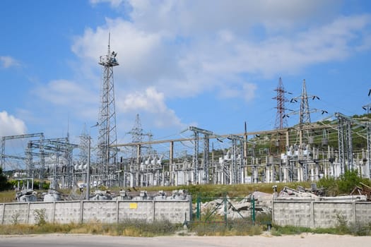 a Power substation equipment, transformers and wire poles.