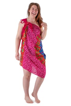 Smiling young woman in red dress stands barefoot against white background
