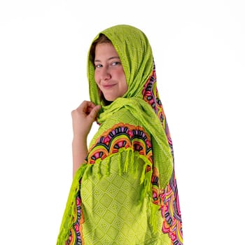 Smiling young girl with a green headscarf looks into the camera isolated on white