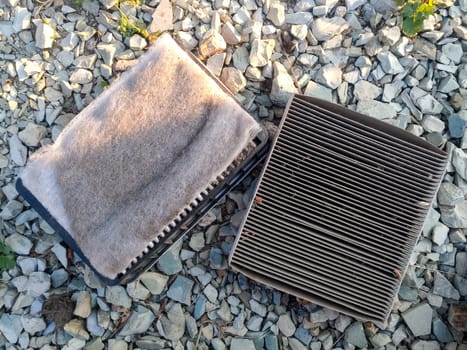 An old dirty filter out of the car. Replacing the air filter.