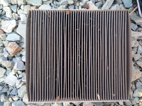 An old dirty filter out of the car. Replacing the air filter.