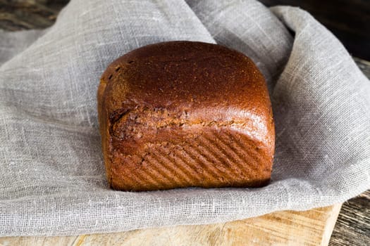 black square loaf of bread made of rye flour