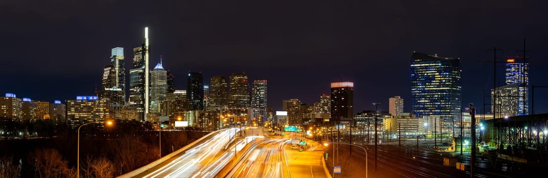 Panorama of Philadelphia skyscraper Skylines building at night illuminated with highway urban road transportation in Philly city downtown of Philadelphia in PA USA. Cityscape Urban lifstyle concept.