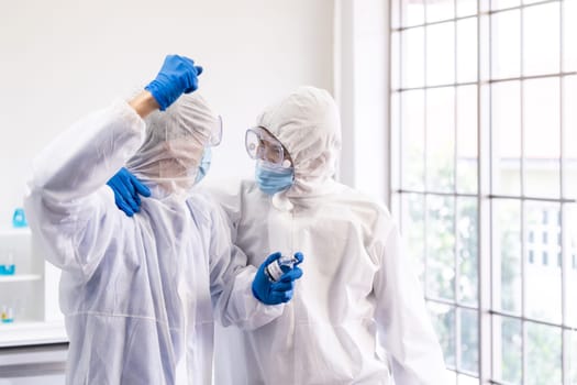 Asian Scientists celebrate for their successful vaccine research and development to immune coronavirus vovid-19 after world pandemic. Medical Science technology and healthcare concept.