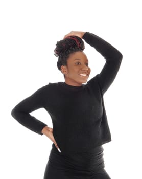 Beautiful African America woman standing in a black dress with one.hand over her head, isolated for white background.