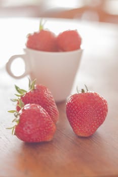 Fresh strawberries on wooden table, stock photo