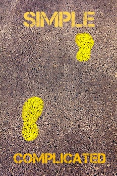 Yellow footsteps on sidewalk from Complicated to  Simple message. Conceptual image