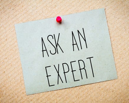 Recycled paper note pinned on cork board.Ask an Expert Message. Concept Image