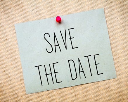 Recycled paper note pinned on cork board.Save the Date Message. Wedding Concept Image