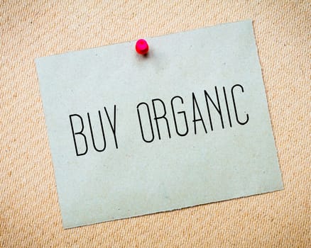 Recycled paper note pinned on cork board.Buy Organic Message. Concept Image