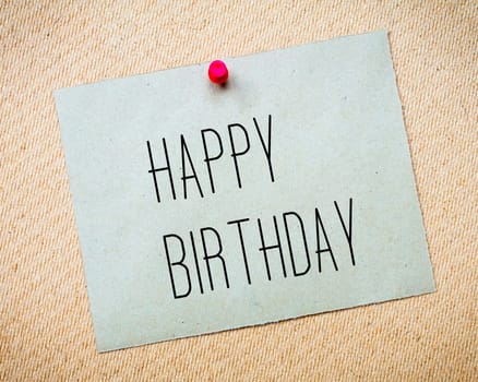 Recycled paper note pinned on cork board.Happy Birthday Message. Concept Image