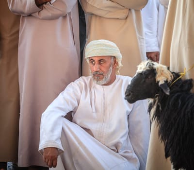 Nizwa, Oman, December 2, 2016: Shoppers at the Friday goat market in Nizwa, Oman
