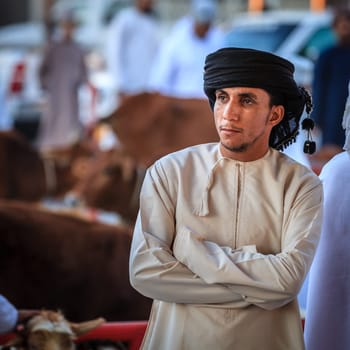 Nizwa, Oman, December 2, 2016: Portrait of a local farmer at the Friday goat market in Nizwa, Oman